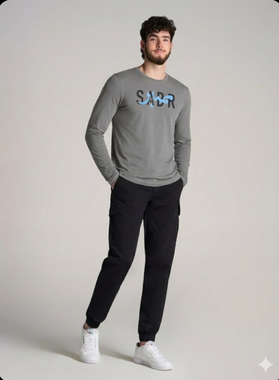 A cool-gray long-sleeve tee finished with a bold SABR graphic for a clean streetwear look.