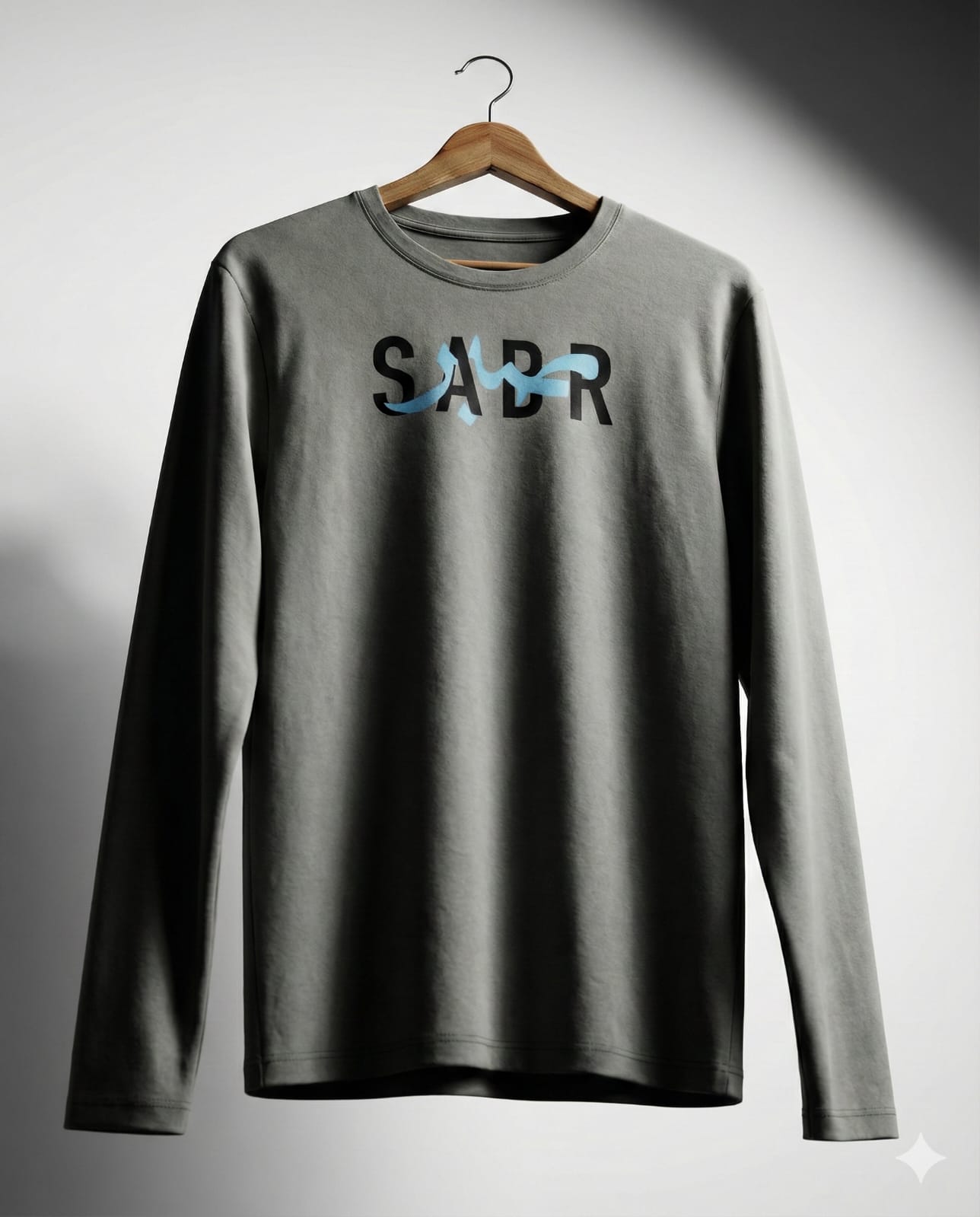 A cool-gray long-sleeve tee finished with a bold SABR graphic for a clean streetwear look.