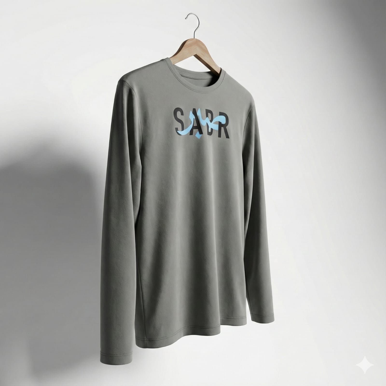 A cool-gray long-sleeve tee finished with a bold SABR graphic for a clean streetwear look.